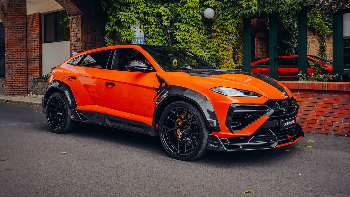 Orange DUMMAR Lamborghini Urus SE with carbon bodykit, front three-quarter view