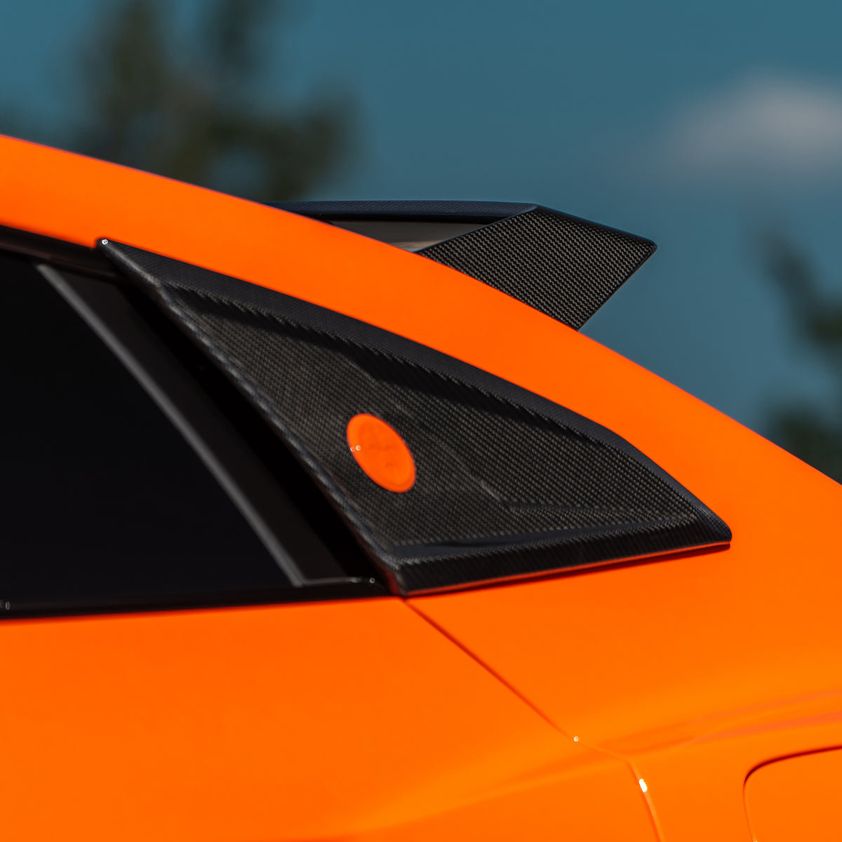 DUMMAR carbon fibre C pillar trim and badge fitted to an orange Lamborghini Urus SE