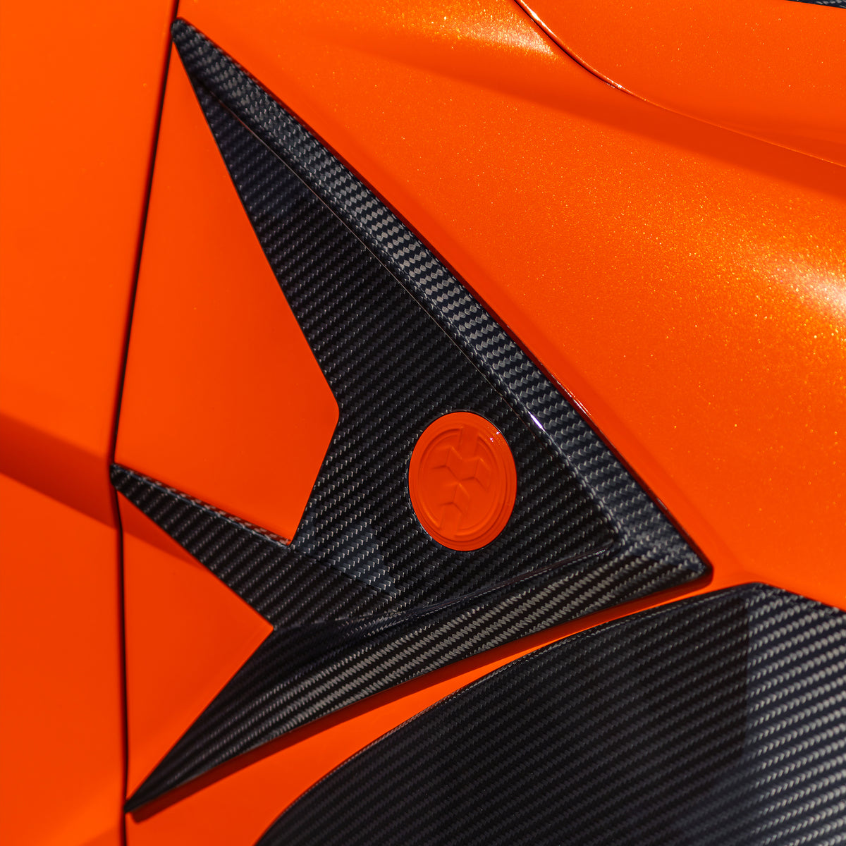 DUMMAR carbon fibre fender trim and badge fitted to an orange Lamborghini Urus SE