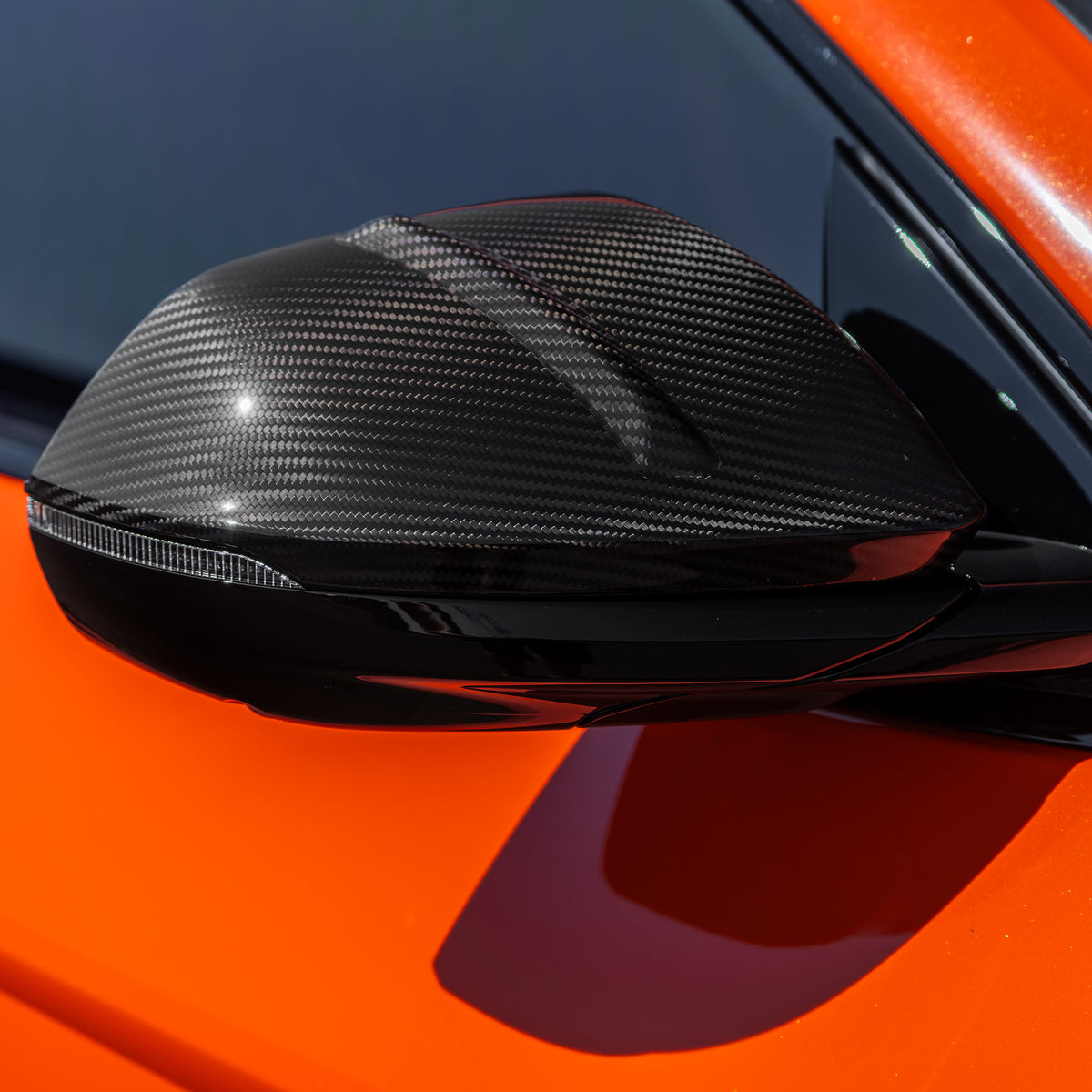 DUMMAR carbon fibre mirror cap fitted to an orange Lamborghini Urus SE